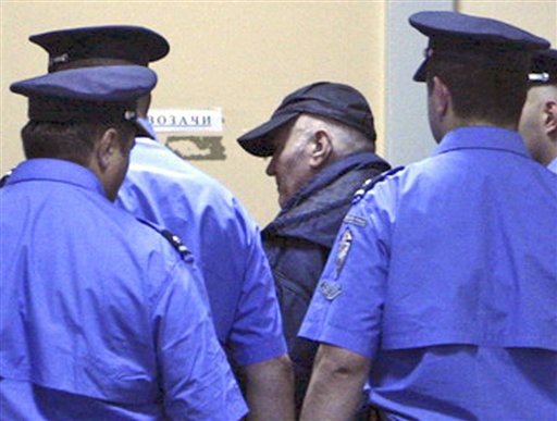 In this handout image released by the Serbian government Thursday, May 26, 2011,  Ratko Mladic  enters court in Belgrade, Thursday, May 26, 2011.  Ratko Mladic, in baseball cap,  the ruthless Bosnian Serb military leader charged with orchestrating Europe's worst massacre of civilians since World War II, was arrested before dawn at a relative's home in a tiny Serbian village on Thursday after a 16-year hunt for the architect of what a war-crimes judge called "scenes from hell."  (AP Photo / Serbian Government, HANDOUT) (AP)