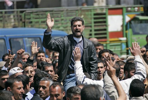 ** CORRECTS SPELLING OF LEBANESE  ** Syrian citizens who fled from violence from the western Syrian villages along the Lebanese-Syrian border, protest as they shout slogans against Bashar Assad and his regime, in the Wadi Khaled area, about one kilometer (0.6 miles) from the Lebanon-Syria border, north Lebanon, on Monday May 16, 2011. Carrying mattresses and bags of clothing, Syrians fleeing their homeland described a "catastrophic" scene Monday in a besieged border town that has been largely sealed off as the army tries to crush a two-month uprising. (AP Photo) (AP)