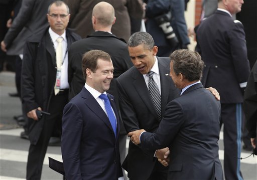 Russian President Federation Dmitry Medvedev, left, and President Barack Obama are greeted by French President Nicolas Sarkozy as they arrive at the G8 Summit, in Deauville, France, Thursday, May 26, 2011. (AP Photo/Carolyn Kaster) (AP)