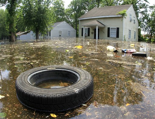 Trash floats by flooded homes on Monday, May 9, 2011, in Memphis, Tenn. The swollen Mississippi River could crest as early as Monday night. (AP Photo/Mark Humphrey) (AP)