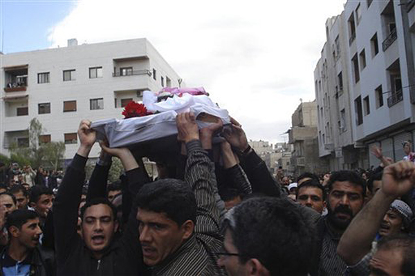In this citizen journalism image made on a mobile phone and acquired Saturday April 23, 2011, by The AP, Syrian anti-government protesters carry the coffin of an activist who was killed on Friday during his funeral procession in Quaboun near Damascus, Syria, Saturday, April 23, 2011.  Syrian security forces fired on tens of thousands of mourners during funeral processions Saturday, killing several people following the deadliest day of the uprising against authoritarian President Bashar Assad. (AP Photo) (Str)