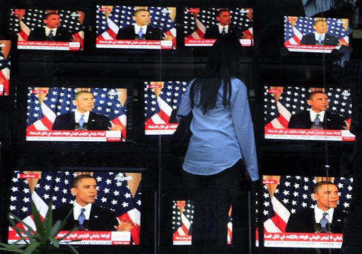 An Egyptian woman watches U.S. President Barack Obama's policy address, outside a shop selling televisions in Cairo, Egypt Thursday, May 19, 2011. President Barack Obama on Thursday endorsed a key Palestinian demand for the borders of its future state and prodded Israel to accept that it can never have a truly peaceful nation based on "permanent occupation." (AP Photo/Amr Nabil) (AP)