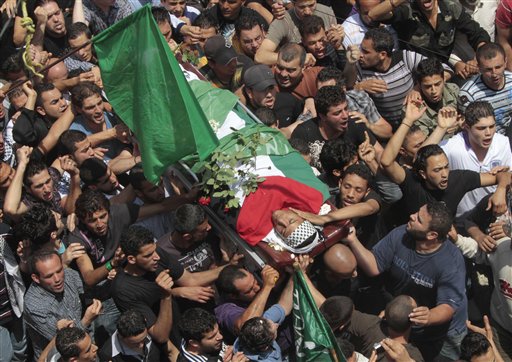 Palestinian mourners carry the body of a Palestinian man who killed when Israeli soldiers opened fire on Sunday at protesters who approached the northen Israeli border with Lebanon, during a funeral procession at Ein el-Hilweh Palestinian refugee camp, in the southern port city of Sidon, southern Lebanon, on Monday May 16, 2011. Israeli troops clashed with Arab protesters along three hostile borders on Sunday, leaving as many as 12 people dead and dozens wounded in an unprecedented wave of violence marking the anniversary of the mass displacement of Palestinians surrounding Israel's establishment in 1948. (AP Photo/Mohammed Zaatari) (AP)