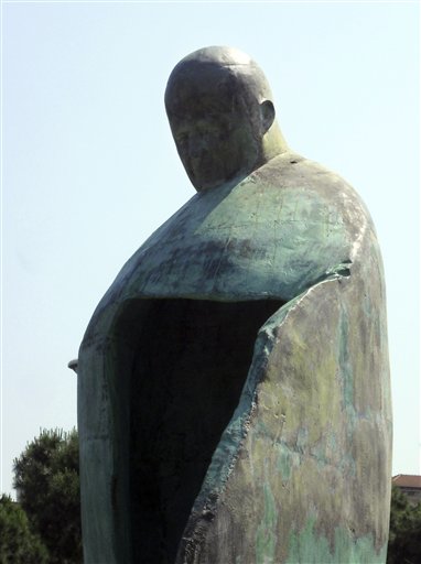 A giant bronze sculpture portraying Pope John Paul II is displayed outside Rome's Termini train Station, Friday, May 20, 2011. The Vatican is dismayed by a giant new sculpture portraying Pope John Paul II, saying the towering bronze work outside Rome's main train station doesn't even look like the late pontiff. Vatican newspaper L'Osservatore Romano says Friday the towering modernistic statue gives the impression a bomb hit the square. The artist, Oliviero Rainaldi, depicts the pontiff as if he is opening his cloak to embrace faithful. But the Vatican says the effect is more like a police sentry box than of a welcoming pontiff. (AP Photo/Marco Guerrieri) (AP)