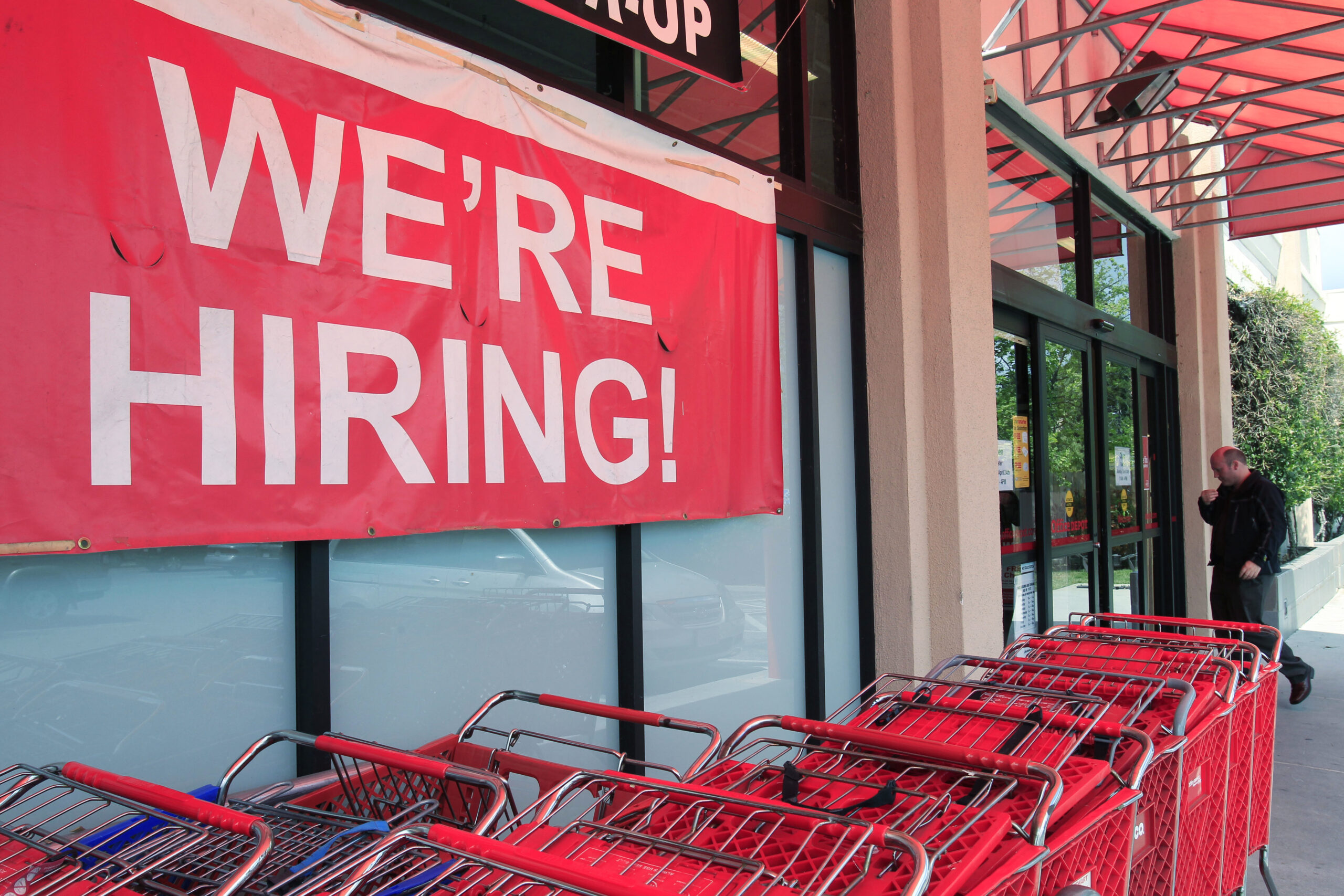 In this April 25, 2011 photo, a "We're Hiring!" sign is shown at Office Depot in Mountain View, Calif. More people sought unemployment benefits last week, the second rise in three weeks, a sign the job market's recovery is slow and uneven.(AP Photo/Paul Sakuma) (AP)