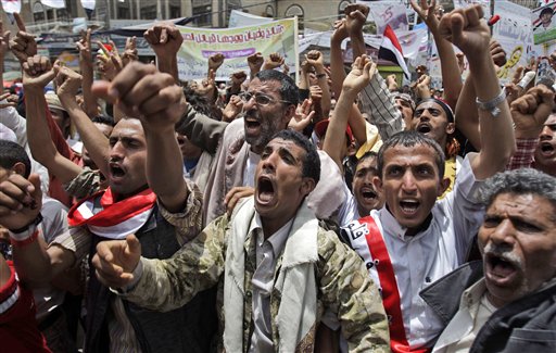 Anti-government protestors, shout slogans during a demonstration demanding the resignation of Yemeni President Ali Abdullah Saleh, in Sanaa, Yemen, Monday, May 23, 2011.   (AP Photo/Hani Mohammed) (AP)
