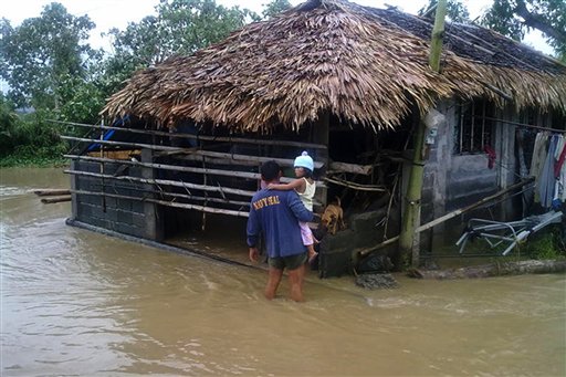 In this photo released by the Philippine Naval Forces Southern Luzon, a Disaster Response and Rescue Team member holds a child as they evacuate families at an area flooded by Tropical Storm Aere in Libon town, Albay province, eastern Philippines on Monday May 9, 2011. Disaster officials warned villagers in the Philippines' agricultural north to be on guard for landslides and flash floods Monday as Tropical Storm Aere carved a deadly path across the country. (AP Photo/Philippine Naval Forces Southern Luzon) NO SALES (AP)