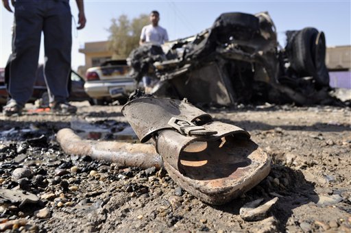A discarded sandal is seen amid debris and destroyed vehicles the morning after four blasts killed several people in Ramadi, 70 miles (115 kilometers) west of Baghdad, Iraq, Friday, June 3, 2011. The blasts in what was the heartland of the al-Qaida-led insurgency are a reminder of the danger still facing Iraq, as it prepares for the departure of the remaining U.S. troops by the end of this year.(AP Photo) (AP)