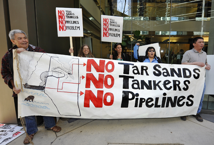 First nations natives from British Columbia protest in front of the headquarters of Enbridge before the company's annual general meeting in Calgary, Alberta, May 11, 2011. The natives are protesting an oil pipeline that will go through their land. REUTERS/Todd Korol  (CANADA - Tags: BUSINESS ENERGY CIVIL UNREST) (Â© Todd Korol / Reuters)