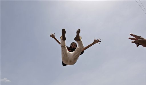 An anti-government protestor is thrown in to the air by others while celebrating President Ali Abdullah Saleh's departure to Saudi Arabia, in Sanaa, Yemen, Sunday, June 5, 2011. Thousands of protesters are dancing and singing in the Yemeni capital Sanaa after the country's authoritarian leader flew to Saudi Arabia to receive medical treatment for wounds he suffered in a rocket attack on his compound. (AP Photo/Hani Mohammed) (AP)