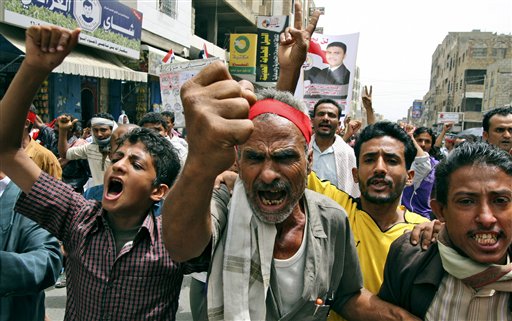 Anti-government protestors shout slogans during a demonstration demanding the resignation of Yemeni President Ali Abdullah Saleh, in Taiz, Yemen, Sunday, June 19, 2011. (AP Photo/Anees Mahyoub) (AP)