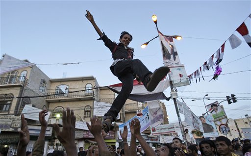 Anit-government protestors reach to catch a youth, after throwing him in to the air while celebrating President Ali Abdullah Saleh's departure to Saudi Arabia, in Sanaa, Yemen, Monday, June 6, 2011. A cease-fire in Yemen's capital was at risk of unraveling Monday as regime supporters opened fire on opposition fighters in renewed clashes that killed at least six. The violence raises fears over the potentially explosive situation after the wounded President Ali Abdullah Saleh left the country, creating a deep power vacuum. (AP Photo/Hani Mohammedi) (AP)