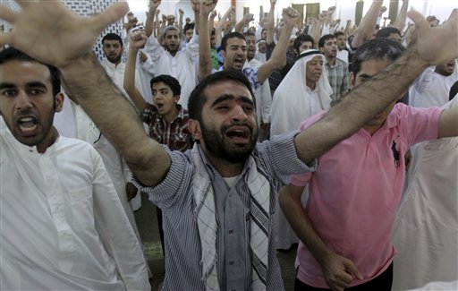 Bahraini Shiite Muslims chant slogans to free prisoners during a sermon Friday, June 10, 2011, in Diraz, Bahrain, when Sheik Issa Qassem, Bahrain's top Shiite cleric, said Bahrain should free political prisoners and that the nation's reputation is being damaged by prosecuting doctors, teachers, youths, women, clerics and other professionals arrested during the crackdown on anti-government protesters. Many Shiite Muslim clerics, including Sheik Ali Salman, leader of the largest opposition party, attended midday prayers in Diraz, an unusual move to show their solidarity with Qassem. (AP Photo/Hasan Jamali) (AP)
