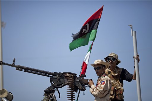 Rebel soldiers provide security outside the hotel where Italy's Foreign Minister Franco Frattini signed a memorandum of understanding  with rebel officials in Benghazi, Libya, Tuesday , May 31, 2011. Italy's foreign minister says Rome has signed a deal with Libya's rebels to provide them with a credit line of hundreds of millions of euros. (AP Photo/Rodrigo Abd) (AP)