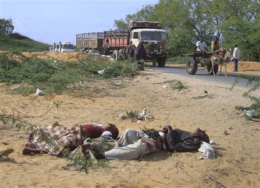 EDS NOTE: GRAPHIC CONTENT - This photo taken Wednesday, June 8, 2011 shows Fazul Abdullah Mohammed, left, and another unidentified man lying dead in Mogadishu, Somalia.  A Somali official says the al-Qaida operative behind the 1998 U.S. Embassy bombings in Kenya and Tanzania has been killed. The spokesman for Somalia's minister of information, Abdifatah Abdinur, said Saturday June 11, 2011 that officials have concluded that a man security forces killed late Tuesday was Fazul Abdullah Mohammed. Fazul had a $5 million bounty on his head for allegedly planning the 1998 embassy bombings. (AP Photo/Farah Abdi Warsameh) (AP)