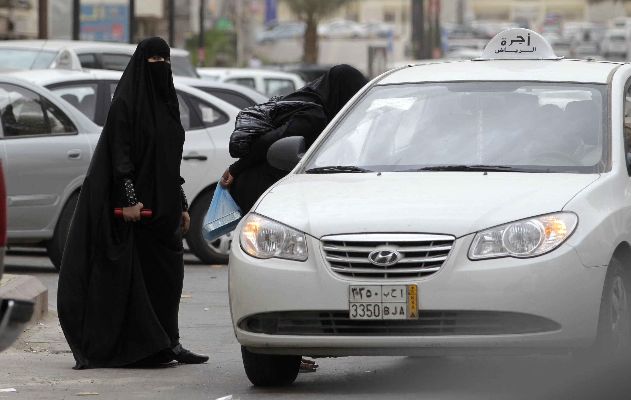 FILE - In this Tuesday, May 24, 2011 file photo, Saudi women board a taxi in Riyadh, Saudi Arabia. A campaign to defy Saudi Arabia's ban on women driving opened Friday, June 17, 2011 with female motorists getting behind the wheel, including one who took a 45-minute tour through the nation's capital, amid calls for sustained challenges to the restrictions in the ultraconservative kingdom. (AP Photo/Hassan Ammar, File) (Associated Press)