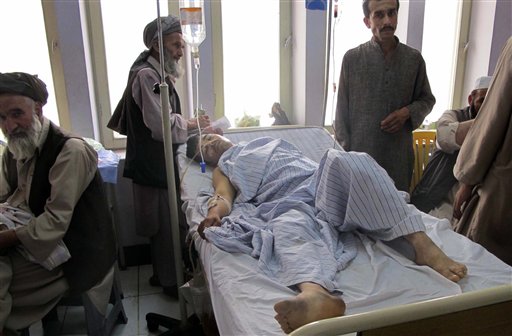 An injured Afghan man, a victim of a blast lies in a hospital bed in Kunduz city in the northern province of Kunduz, Afghanistan, Saturday, June 25, 2011. A bicycle rigged with explosives ripped through a bazaar in the Khanabad district of Kunduz province on Friday, killing at least 10 people, including a police officer. At least 24 people were wounded in the attack, according to an Interior Ministry statement. (AP Photo/Balal) (AP)
