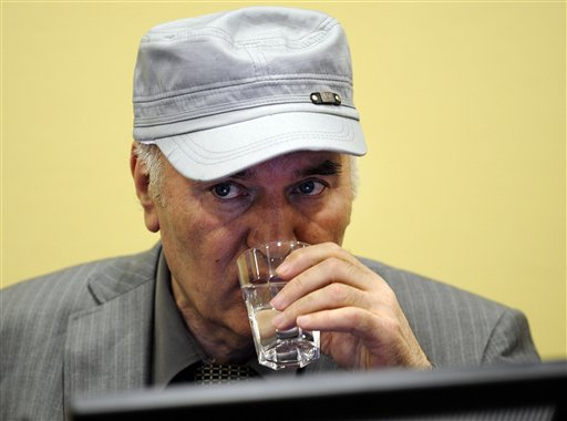 Former Bosnian Serb Gen. Ratko Mladic drinks water in the court room during his initial appearance at the U.N.'s Yugoslav war crimes tribunal in The Hague, Netherlands, Friday, June 3, 2011. Mladic's appearance Friday at the Yugoslav war crimes tribunal in The Hague is his first public appearance since he went into hiding nearly 16 years ago, when he was indicted for genocide and war crimes committed in the 1992-95 Bosnian war. (AP Photo/ Martin Meissner, Pool) (AP)