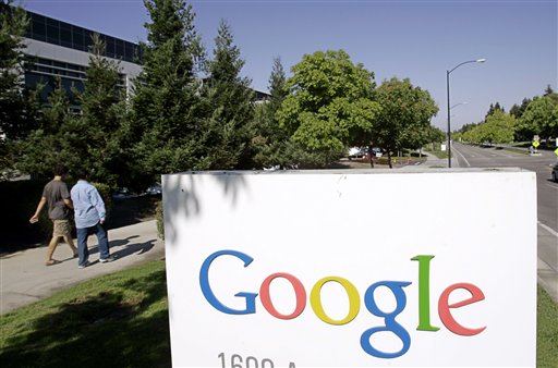 FILE - In this July 17, 2006 file photo, Google workers walk by a Google sign at company headquarters in Mountain View, Calif. Google says computer hackers in China broke into the Gmail accounts of several hundred people, including senior government officials in the U.S. and political activists. The attacks announced Wednesday, June 1, 2011 on Google's blog aren't believed to be tied to a more sophisticated assault originating from China in late 2009 and early last year. (AP Photo/Paul Sakuma, File) (AP)