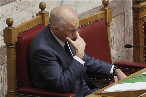 Greek Prime Minister George Papandreou grimases before to give a speech in parliament during an emergency meeting of Socialist lawmakers, in Athens on Thursday, June 16, 2011. Papandreou vowed to stay on as prime minister, despite a party revolt that broke out Thursday against a new austerity measures that have triggered violent street protests ad widespread discontent.(AP Photo/Petros Giannakouris) (AP)