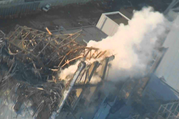 An aerial view shows steam rising from the No. 3 reactor at the Fukushima Daiichi nuclear power complex on March 16