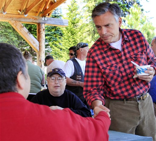 With his wife Mary Kaye at his side possible 2012 presidential hopeful, former Republican Gov. Jon Huntsman, Jr., of Utah shakes hands during a cultural festival at Heritage Park, Saturday, June 4, 2011 in Berlin, N.H. (AP Photo/Jim Cole) (AP)