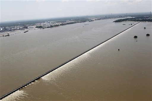 Water from the Mississippi River, left, is seen from the air as it is diverted through the floodgates of the Bonnet Carre Spillway towards Lake Pontchartrain (not pictured) in Norco, La., just upriver from New Orleans, Friday, June 3, 2011. (AP Photo/Gerald Herbert) (AP)