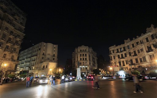 In this photo taken Monday, June 13, 2011, Egyptians walk at Talat Harb square in downtown Cairo, Egypt. A five-month old curfew, established in three Egyptian cities by fallen President Hosni Mubarak to quell protesters attempting to overthrow his government, will be lifted Tuesday at midnight, marking a symbolic return to post-revolution normalcy. (AP Photo/Khalil Hamra) (AP)