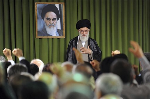 In this photo released by the official website of the Iranian supreme leader's office, Iranian supreme leader Ayatollah Ali Khamenei, places his hand on his heart as a gesture of respect to the lawmakers, foreground, as some of them clench their fists while chanting slogans, at the start of their meeting, in Tehran, Iran, Sunday, May 29, 2011. A picture of the late revolutionary founder Ayatollah Khomeini hangs at rear. (AP Photo/Office of the Supreme Leader)  EDITORIAL USE ONLY  NO SALES (AP)