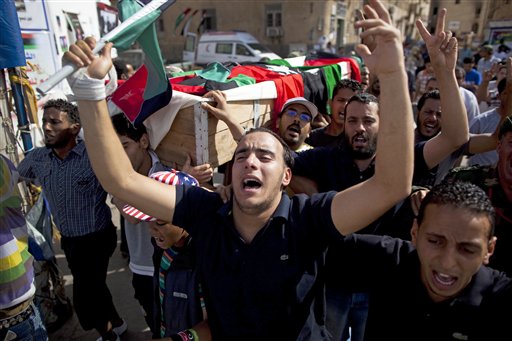 People carry the coffin of a rebel fighter killed on the front line against Moammar Gadhafi's forces during his burial next to the Transitional National Council headquarters in rebel stronghold Benghazi, Libya, Saturday, May 4, 2011. (AP Photo/Rodrigo Abd) (AP)