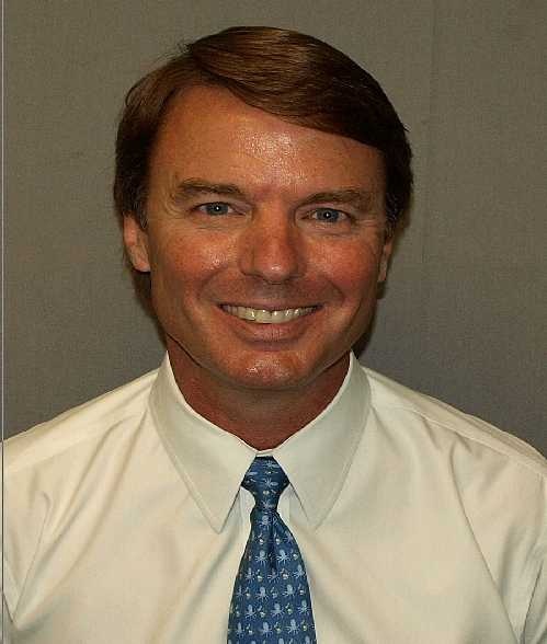 Edwards sports a cold, dead smile in his mugshot
