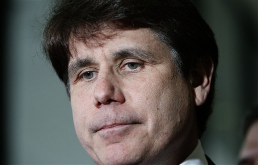 FILE - In this June 9, 2011 file photo, former Illinois Gov. Rod Blagojevich pauses as he talks with reporters at the Federal Court building after the judge handed the case to the jury in his corruption trial in Chicago. Jurors deliberating in Blagojevich's corruption trial told a judge on Monday, June 27, 2011, that they have reached a verdict on 18 of the 20 counts against him, and attorneys in the case have agreed that the verdict should be read. (AP Photo/Charles Rex Arbogast, File) (AP)