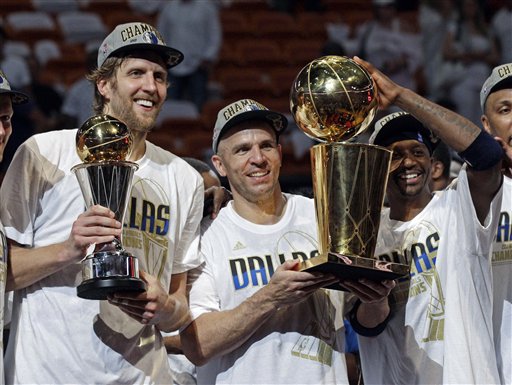 Dallas Mavericks' Dirk Nowitzki, Jason Kidd and Jason Terry hold up their trophies after Game 6 of the NBA Finals basketball game against the Miami Heat Sunday, June 12, 2011, in Miami. The Mavericks won 105-95 to win the series. (AP Photo/David J. Phillip) (AP)