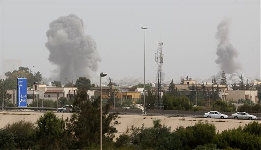 A smoke and dust cloud from an explosions rises into the sky after a NATO airstrike in Tripoli, Libya Tuesday, June 7, 2011. Moammar Gadhafi vowed to fight to the death in a defiant speech Tuesday after NATO military craft unleashed a ferocious series of daytime airstrikes on Tripoli. (AP Photo/Abdel Meguid al-Fergany) (AP)