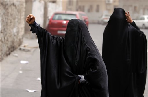 FILE - In this Friday, June 3, 2011 file photo, Bahraini women shout "God is greater" in the streets of the Shiite Muslim neighborhood of Sanabis in Manama, Bahrain, shortly after riot police dispersed anti-government protesters who began a march after the funeral of a woman they claim died of tear gas inhalation the day before. The Shiite groups that speak on behalf of protesters, who took to the streets four months ago to demand greater rights, have shown no rush to embrace the appeals for dialogue by the Sunni monarchs they accuse of creating a two-tier society in the strategic Gulf kingdom. (AP Photo/Hasan Jamali, File) (AP)