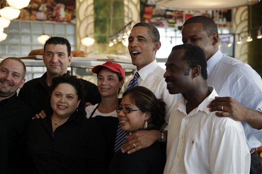 FILE - President Barack Obama, center, and Rep. Kendrick Meek, D-Fla., second from right, pose for photos at Jerry's Famous Deli after a fundraiser for Florida Democrats, in this Aug. 18, 2010 file photo taken in Miami Beach, Fla. President Barack Obama has problems in Florida that he didn't have when he won the pivotal swing state in 2008. The challenges show why Obama has been a frequent visitor to the Sunshine State. (AP Photo/Carolyn Kaster, FILE) (AP)
