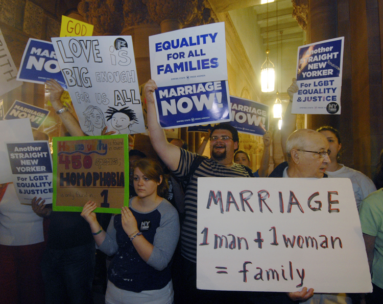 Gay marriage supporters and opponents rally in the hallways at the Capitol in Albany, N.Y., Friday, June 24, 2011.   Security was tight in the Capitol as opponents and supporters of same-sex marriage clogged the marble hallways after a week of rising tensions and great expectations. (AP Photo/Hans Pennink) (Hans Pennink)