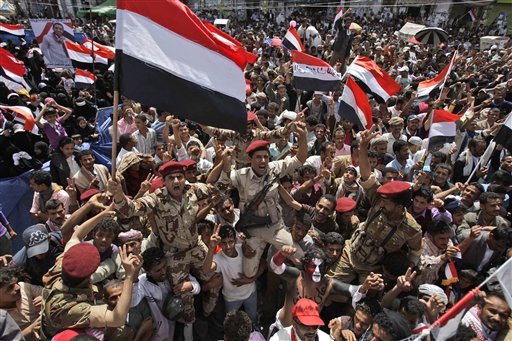 Yemeni army soldiers lifted by anti-government protestors, chants slogans and wave their national flag as they celebrate President Ali Abdullah Saleh's departure to Saudi Arabia, in Sanaa, Yemen, Sunday, June 5, 2011. Thousands of protesters are dancing and singing in the Yemeni capital Sanaa after the country's authoritarian leader flew to Saudi Arabia to receive medical treatment for wounds he suffered in a rocket attack on his compound. (AP Photo/Hani Mohammed) (AP)