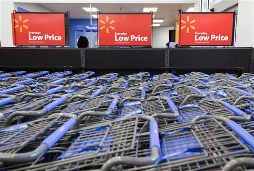 FILE - In this file photo take Dec. 15, 2010, shopping carts are shown inside a Wal-Mart store in Alexandria, Va. As Wal-Mart Stores Inc., the world's largest retailer, restores thousands of products it slashed in an overzealous bid to clean up its stores, it's going back to its roots like catering to enthusiasts of hunting and fishing, while experimenting in new areas. (AP Photo) (AP)
