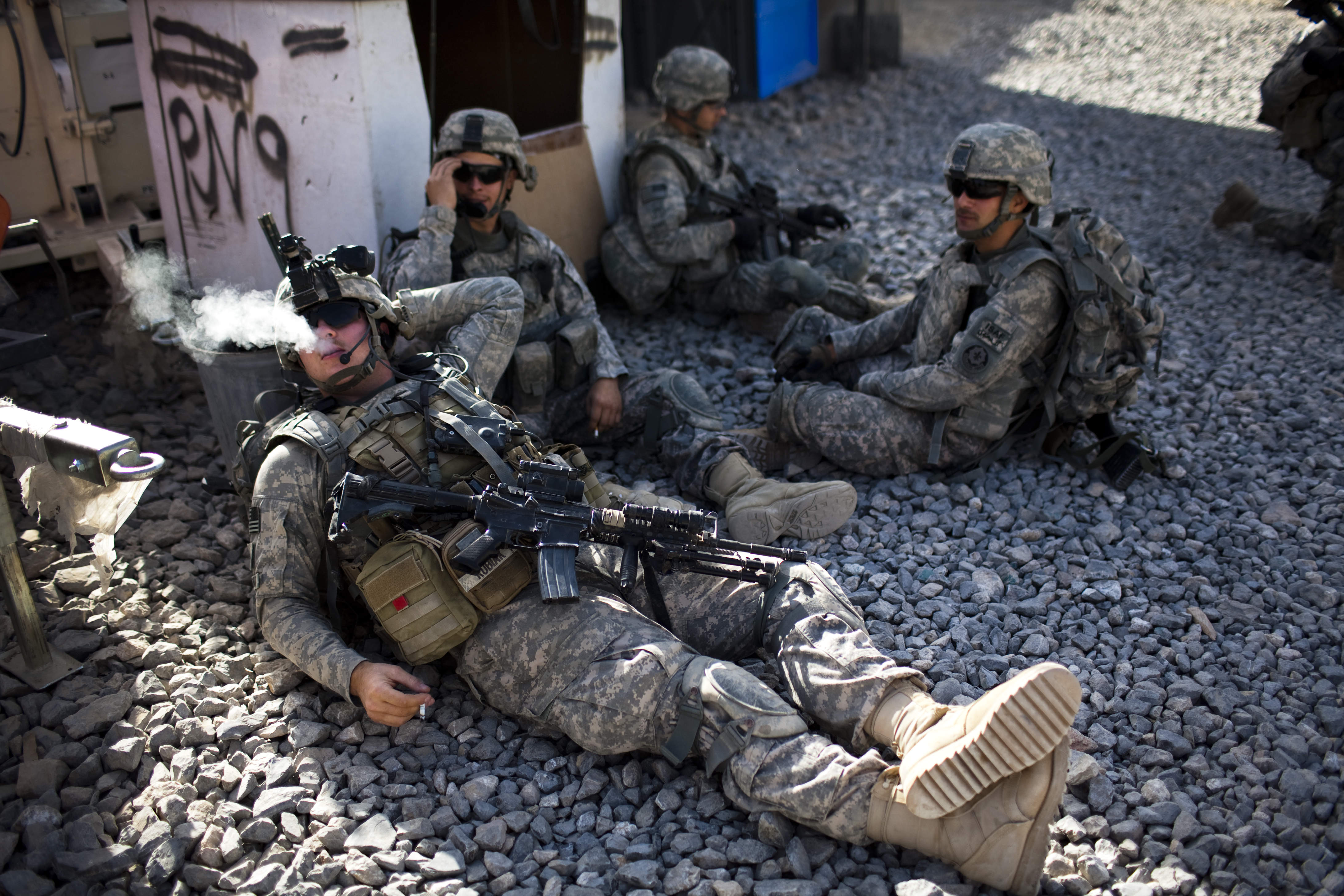 Unidentified US soldiers from L Troop, 4/2SCR, rest, before a foot patrol in Kandahar City, Afghanistan, Friday, Oct. 22, 2010. (AP Photo/Rodrigo Abd) (Associated Press)