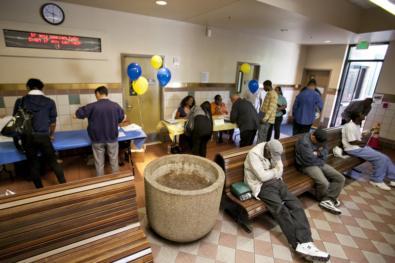 Homeless men sleep on benches while job seekers register at the 10th annual Skid Row Career Fair held at the Los Angeles Mission downtown Los Angeles Thursday, June 2, 2011. Employers hired only 54,000 new workers in May, the fewest in eight months, and the unemployment rate rose to 9.1 percent.(AP Photo/Damian Dovarganes) (Damian Dovarganes)