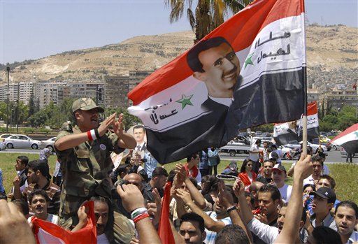 Pro-Syrian regime protesters, shout pro-Syria's President Bashar Assad slogans after he delivered a speech, in Damascus, Syria, Monday, June 20, 2011. Syria's embattled president says "saboteurs" are trying to exploit legitimate demands for reform in the country. President Bashar Assad's speech Monday was only his third public address since the country's uprising began in March. What is happening today has nothing to do with reform, it has to do with vandalism," Assad told a crowd of supporters at Damascus University. "There can be no development without stability, and no reform through vandalism. ... We have to isolate the saboteurs." (AP Photo/Muzaffar Salman) (AP)