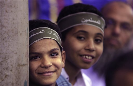 In this Wednesday, May 18, 2011 picture, two Egyptian boys wear headbands reading "Muslim Brotherhood" as they and other supporters attend a Muslim Brotherhood electoral rally in the Munib neighborhood of Cairo, Egypt. Once forced underground, the Brotherhood is likely to be part of Egypt's new government, fueling fears of Islamic rule. But the Brotherhood's own identity is on the line, and there is pressure from inside and out for it not to go down a sharp-right Islamic road. (AP Photo/Nasser Nasser) (AP)