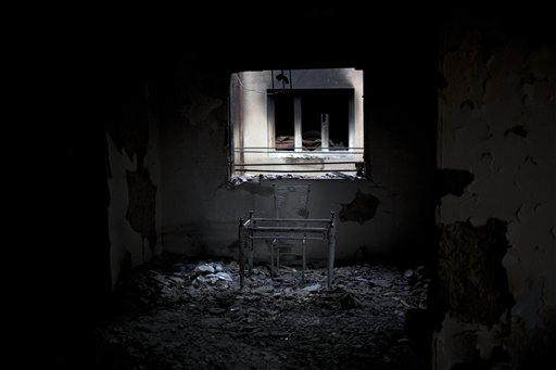 In this photo taken Tuesday, May 24 , 2011, a table and a chair are seen in an apartment used by snipers loyal to Libyan-leader Moammar Gadhafi and destroyed during fighting with rebels for the control of Tripoli Street, Misrata, Libya. Since the weeks-long siege of the city ended in mid-May, Misrata residents make pilgrimages to Tripoli Street, site of the fiercest fighting in the battle for Libya between the rebels and Moammar Gadhafi's forces. People gawk at the wreckage of bombed-out buildings with gaping holes and walls pocked by bullets, and shoot photos of charred hulks of tanks, rubble-strewn streets and a side walk museum featuring drumloads of bullet casings, uniforms of dead enemies, and unexploded munitions. (AP Photo/Rodrigo Abd) (AP)