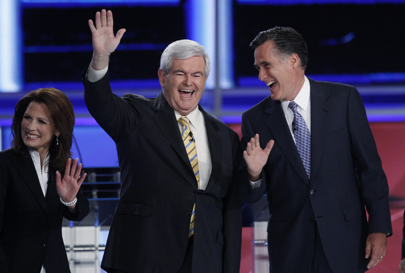 Former Speaker of the U.S. House of Representatives Newt Gingrich (R-GA) (C), former Massachusetts Governor Mitt Romney and U.S. Rep. Michele Bachmann (R-MN), take the stage during a photo opportunity before the start of the first New Hampshire debate of the 2012 campaign at St. Anselms College in Manchester, New Hampshire June 13, 2011. REUTERS/Shannon Stapleton (UNITED STATES  - Tags: POLITICS) (Â© Shannon Stapleton / Reuters)