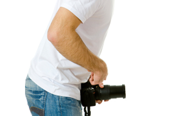 Young man in fool's cap making a sign with referring to the large size, isolated on white (Jkitan)