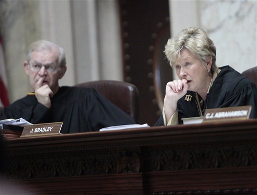 Wisconsin Supreme Court Justices David T. Prosser, Jr. and Ann Walsh Bradley consider oral arguments during a hearing regarding the state's budget bill at the Wisconsin State Capitol, Monday, June 6, 2011. According to a report by Wisconsin Public Radio and the Wisconsin Center for Investigative Journalism, Prosser allegedly grabbed Bradley by the neck with both hands during an argument in Walsh's chambers prior to the court's decision to uphold the bill. (AP Photo/John Hart, Pool) (AP)