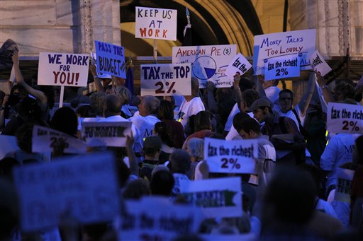 Members of the Minnesota Association of Professional Employees, and the American Federation of State, County and Municipal Employees and their supporters attended a vigil at the State Capitol steps in St. Paul, Minn on Thursday night June 30, 2011. Minnesota stumbled into its second government shutdown in six years on Thursday, with a partisan divide over taxes and spending to close a $5 billion deficit becoming only more bitter as a midnight deadline came and went without agreement. (AP Photo/Carlos Gonzalez - Star Tribune) MANDATORY CREDIT (AP)