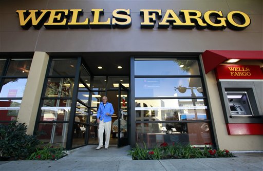 FILE - In this Jan. 18, 2011 file photo, a customer exits a Wells Fargo bank branch in Los Angeles. Wells Fargo & Co. said Tuesday, July 19, 2011, its second-quarter profit rose 30 percent, boosted by a release of reserves set aside to cover souring loans as its customers continued to improve their loan and credit card payments. (AP Photo/Reed Saxon, file) (AP)