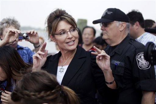 FILE - In this June 1, 2011 file photo, former Alaska Gov. Sarah Palin talks to the media as she leaves Liberty Island in New York.  Palin will visit Iowa, Tuesday, June 28, to attend the premiere of a documentary about her time as governor and her ascent as a national political figure.  (AP Photo/Seth Wenig, File) (AP)